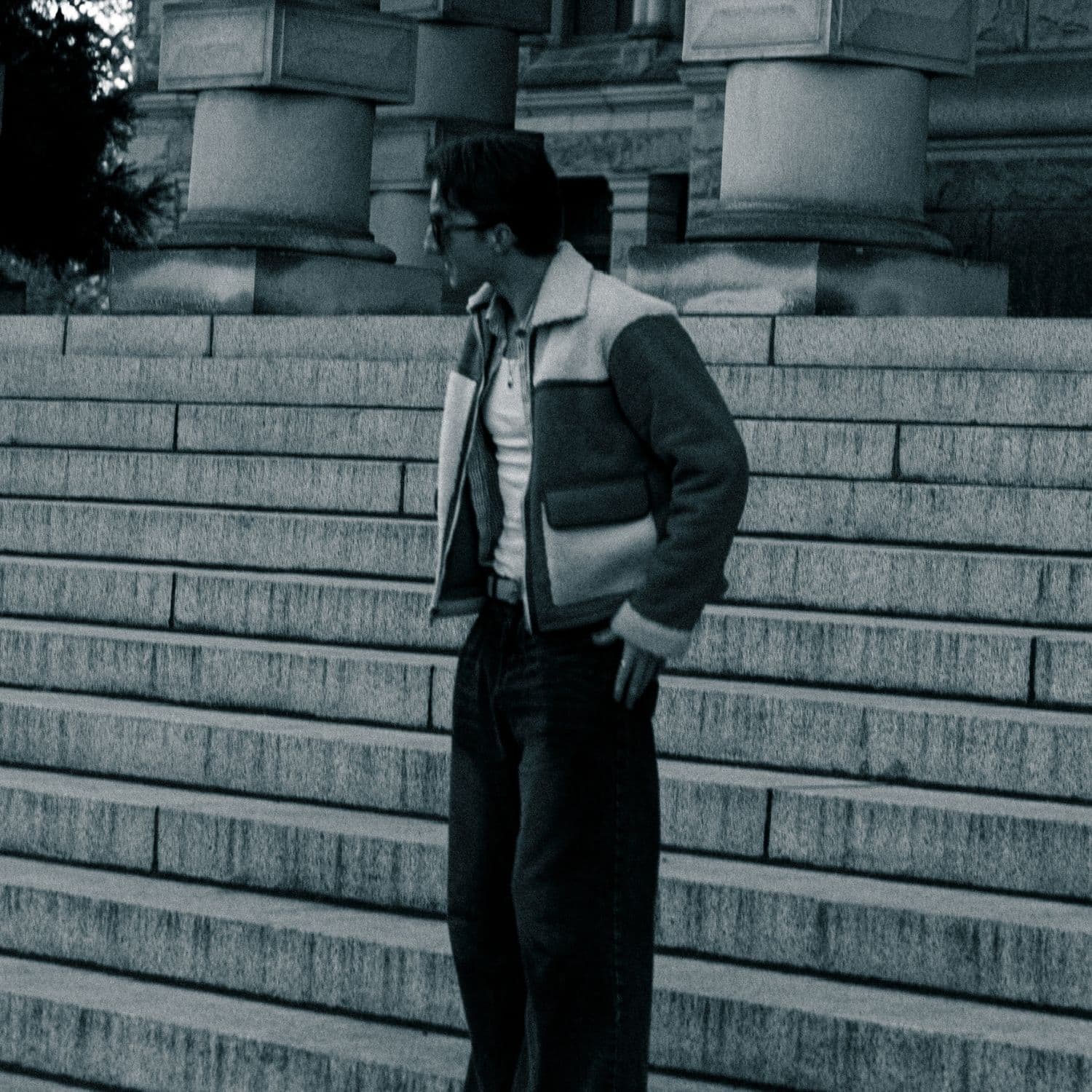 Black and white portrait on stone steps beneath courthouse columns